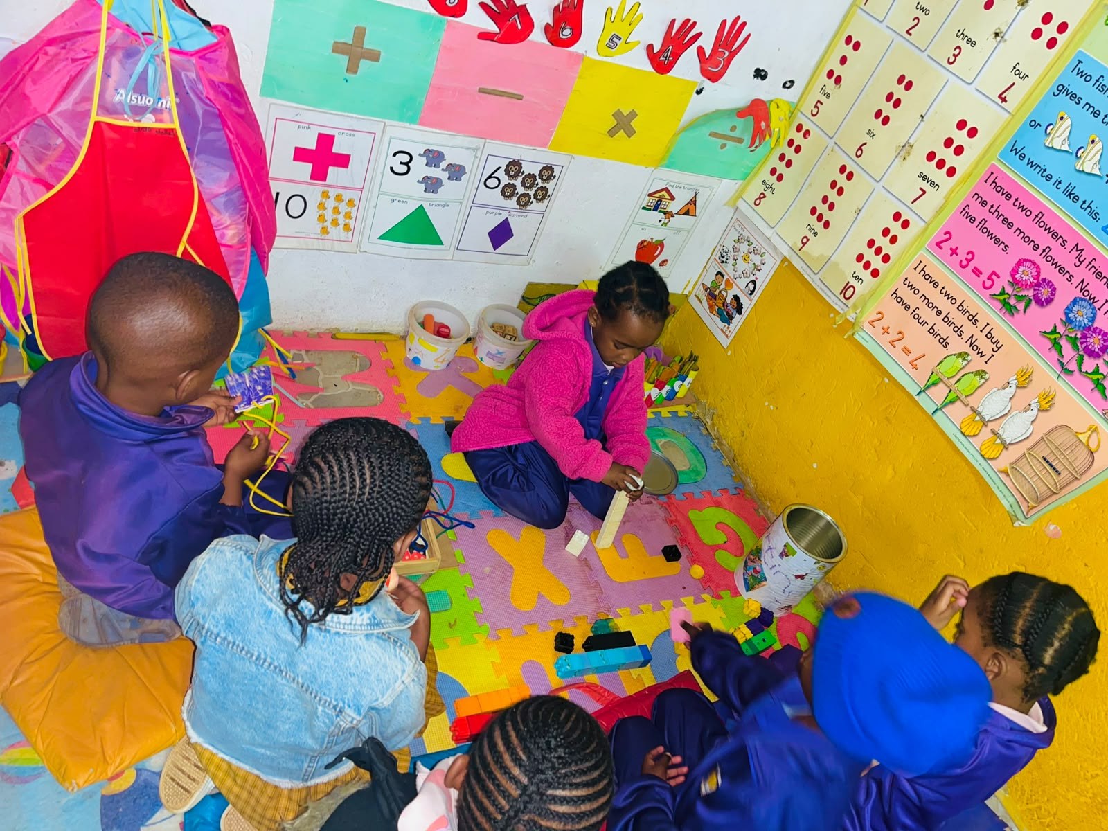 Children playing with shapes and numbers in the learning corner